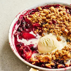 Plum & almond skillet crumble with a scoop of vanilla ice-cream