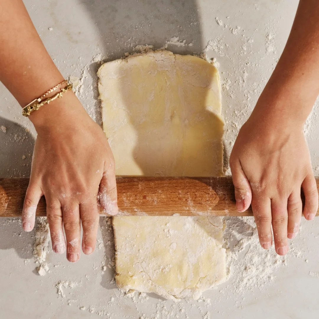 hands rolling pastry sheet