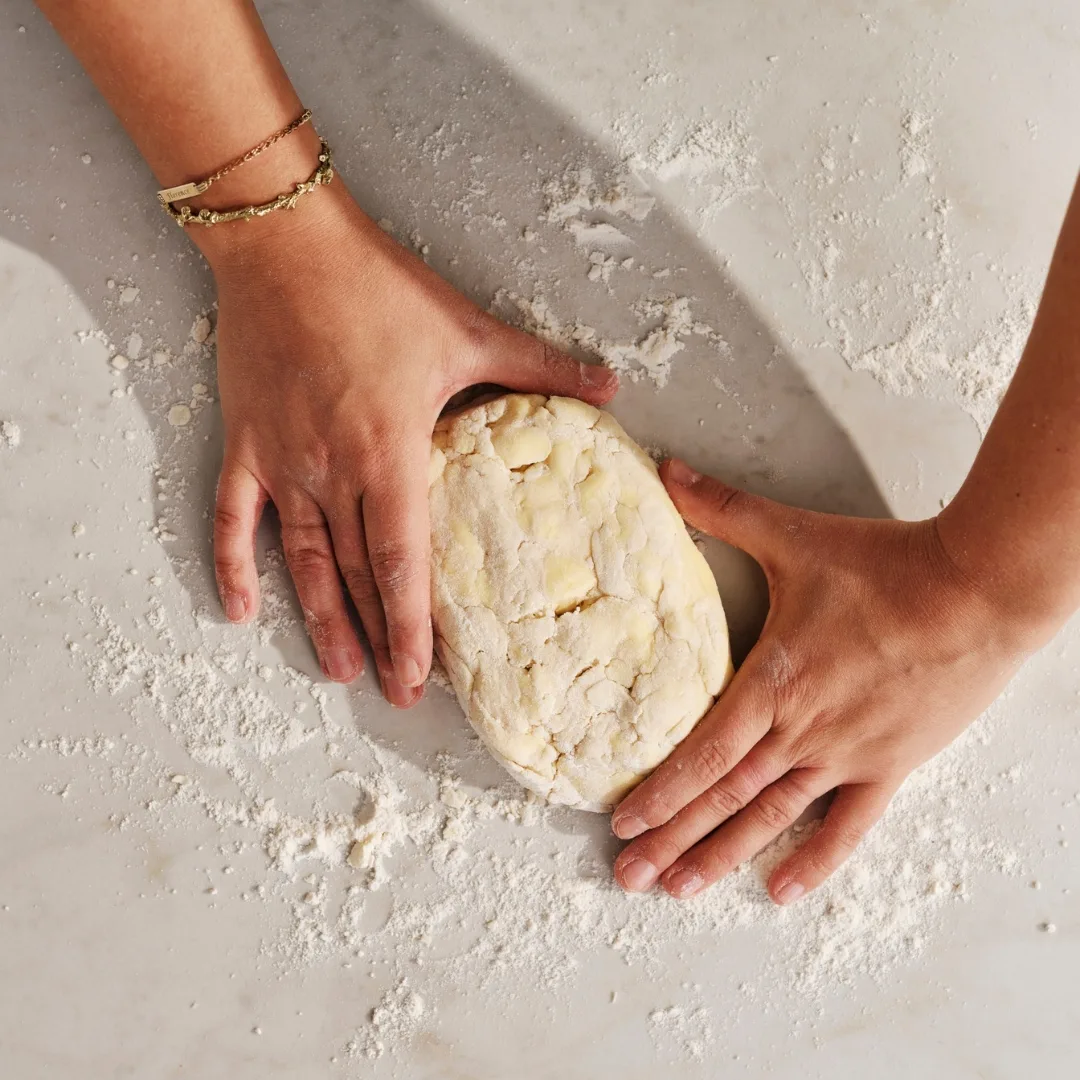 hands holding pastry ball
