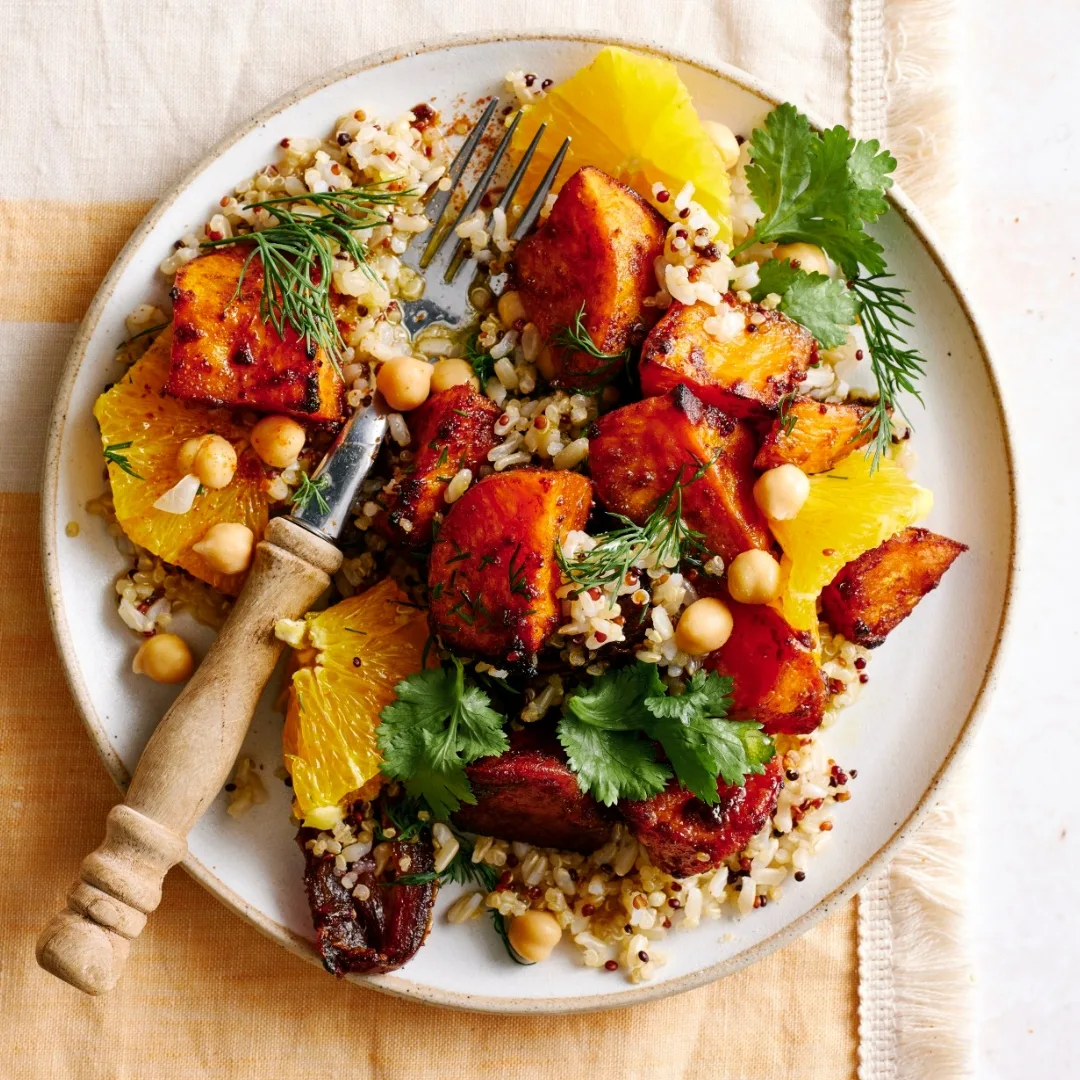 sweet potato salad on a white round plate with a fork