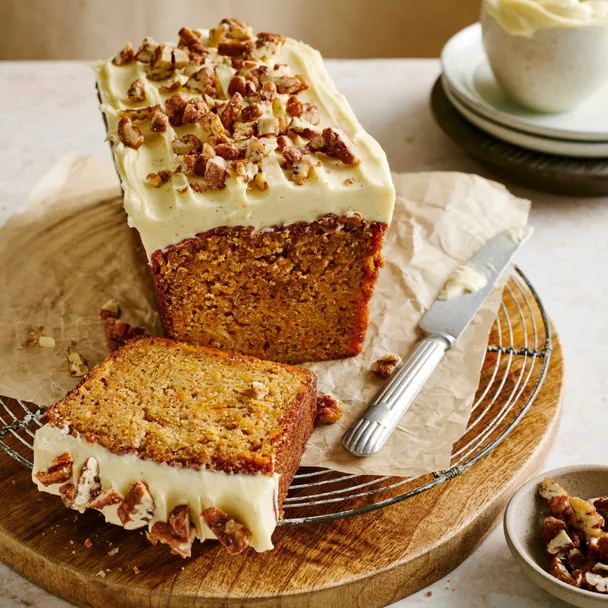 Sweet potato loaf cake on a wooden board with a slice cut