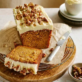 Sweet potato loaf cake on a wooden board with a slice cut
