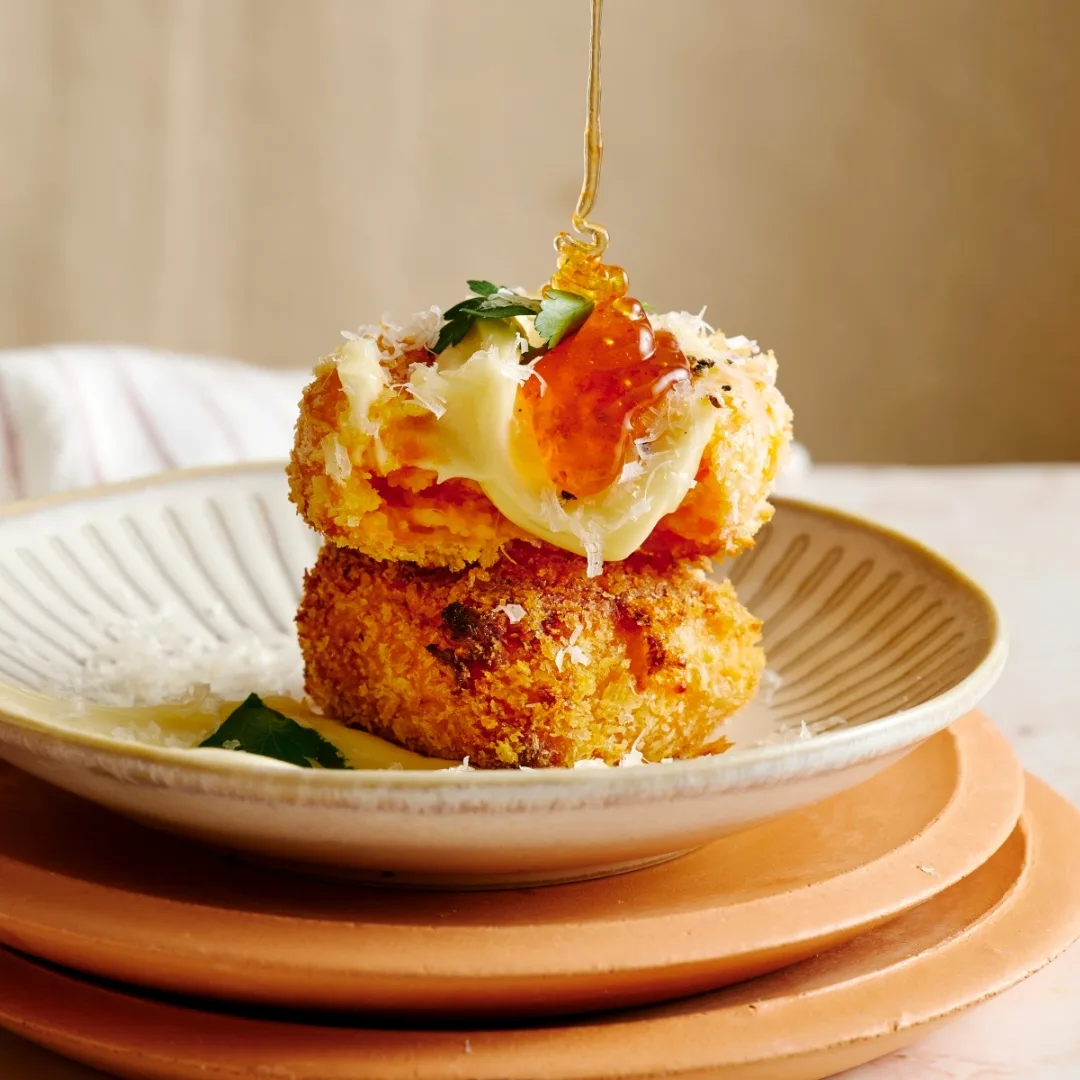 two sweet potato polenta chips drizzled with honey