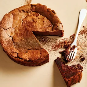 chocolate cake with a piece cut out and a fork