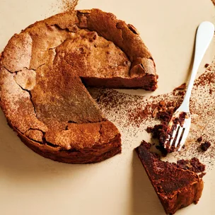 chocolate cake with a piece cut out and a fork
