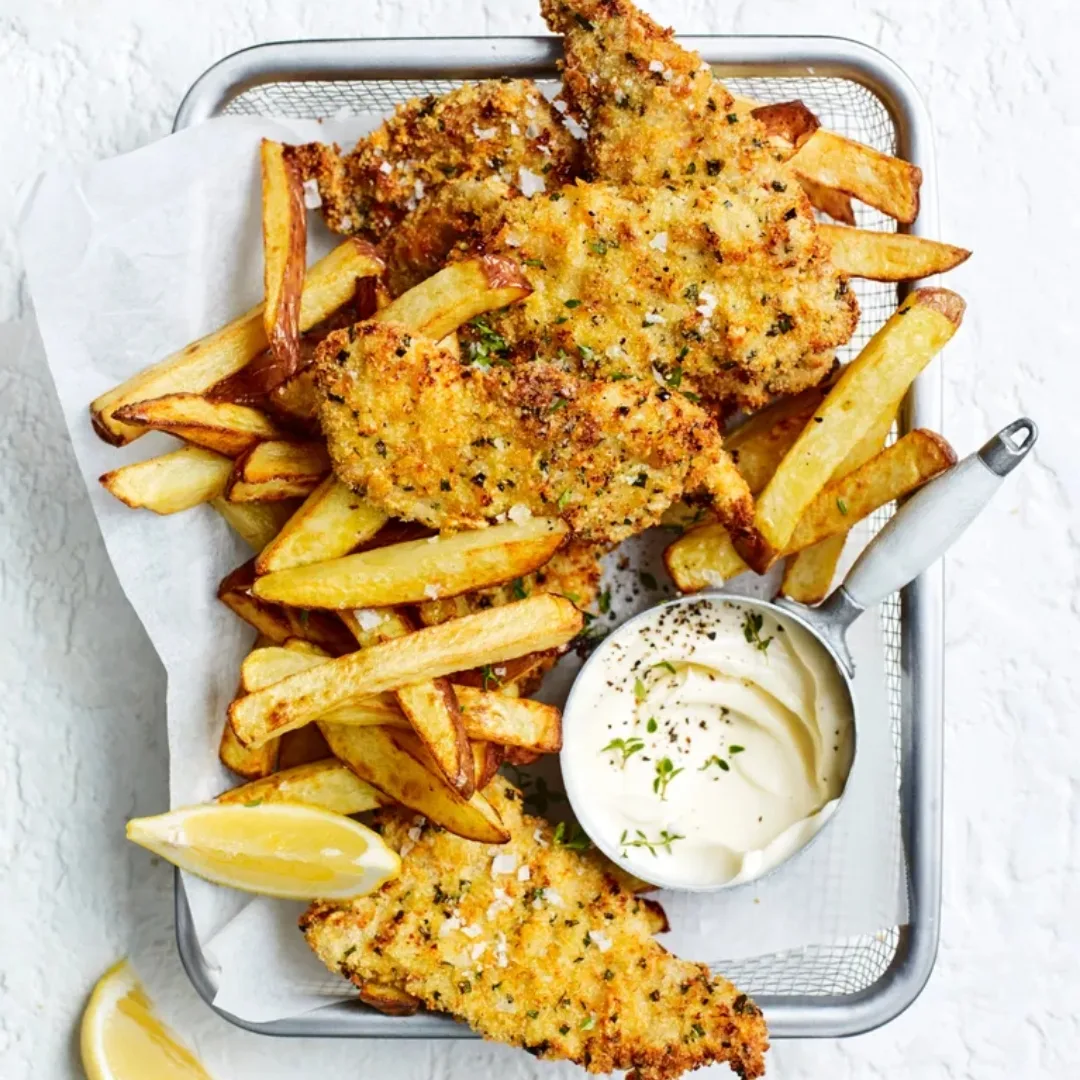 air fryer pork schnitzel dishes with chips and aioli and a metal tray