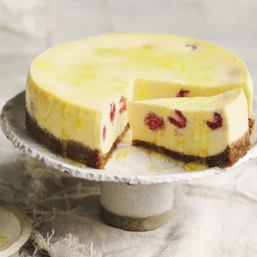 baked ricotta raspberry cheesecake on a cake stand
