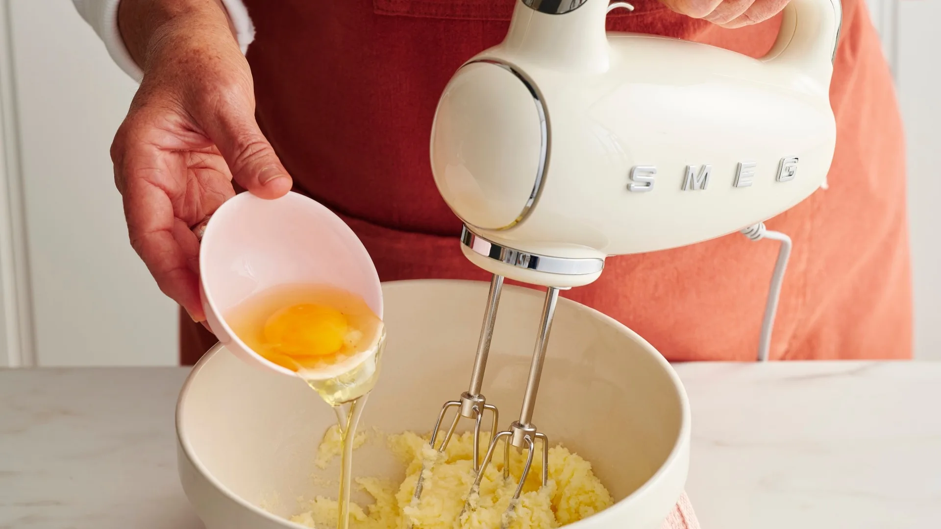 adding egg into the coconut milk cake batter