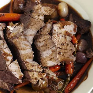 sliced slow roast beef in slow cooker with vegetables
