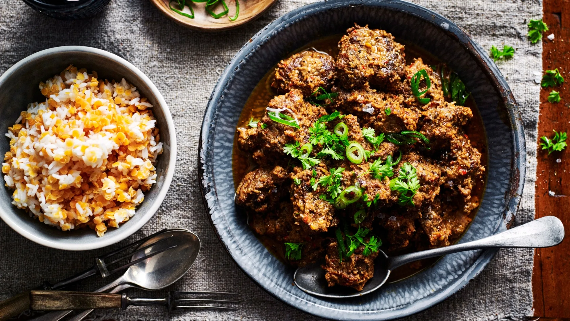 a bowl of beef rendang and a bowl of rice with lentils