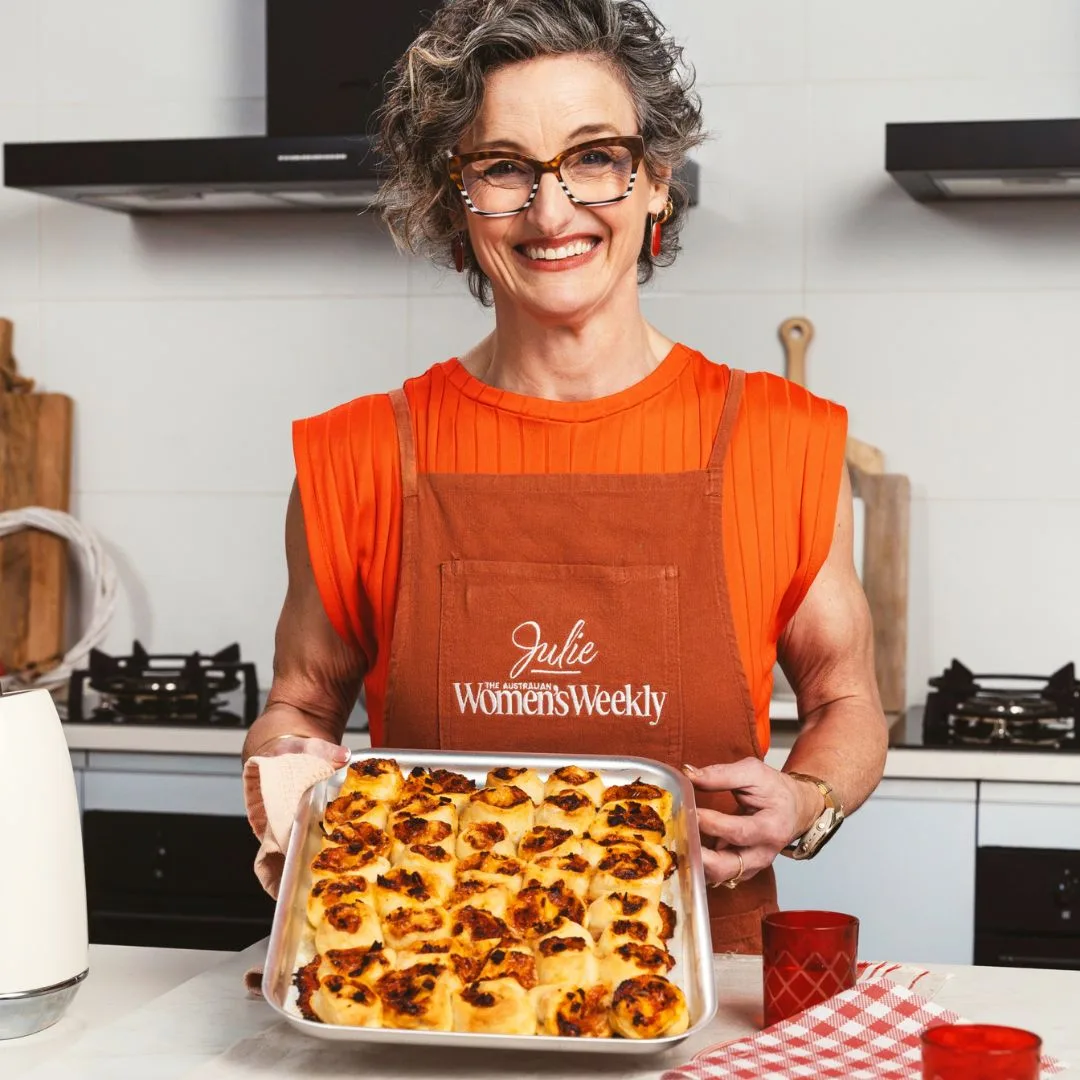Julie Goodwin holds a tray of mini savoury scrolls with pepperoni