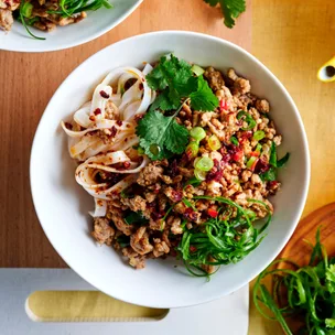 pork larb with rice noodles in a white bowl