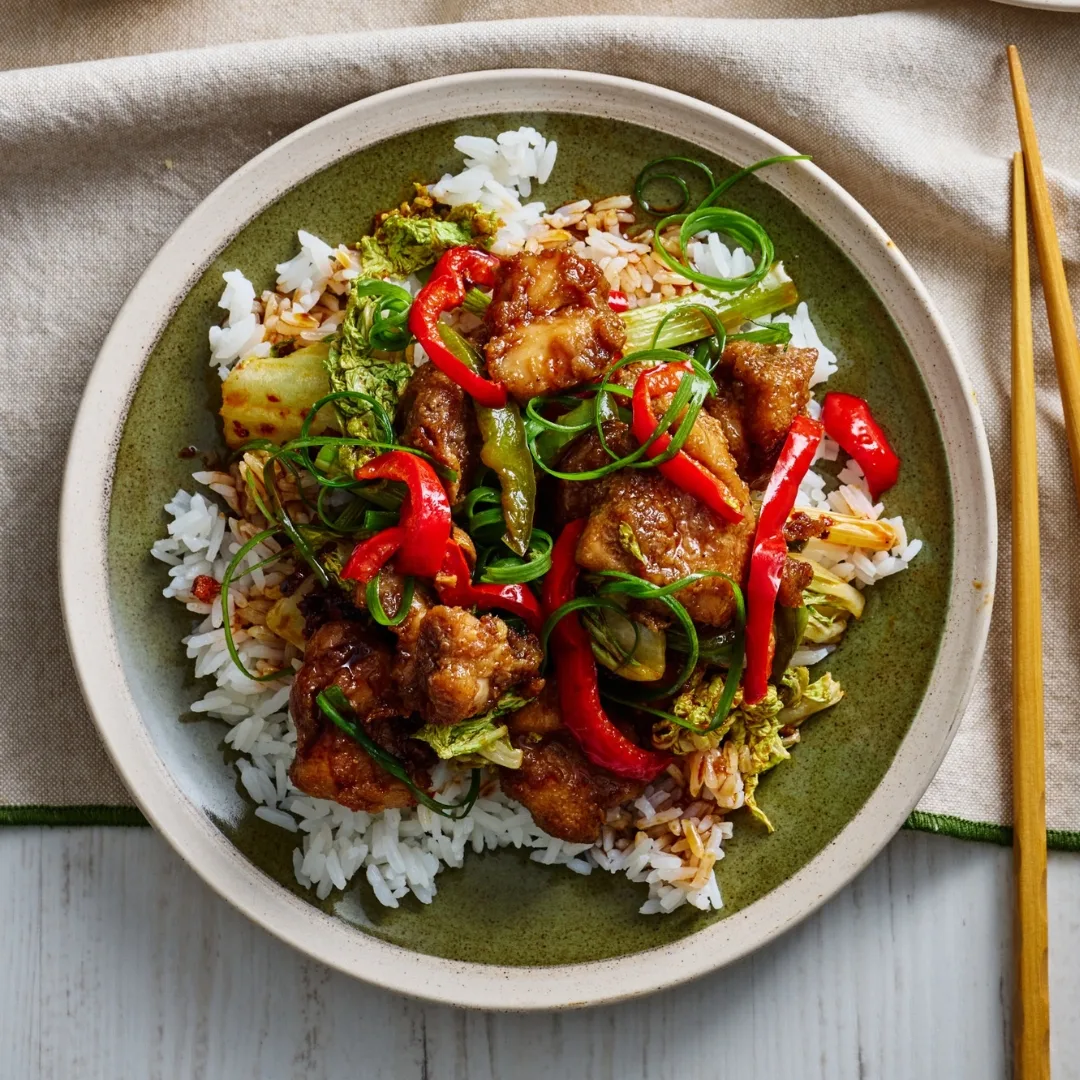 air fryer crispy five spice chicken stir fry with rice on a plate with chopsticks