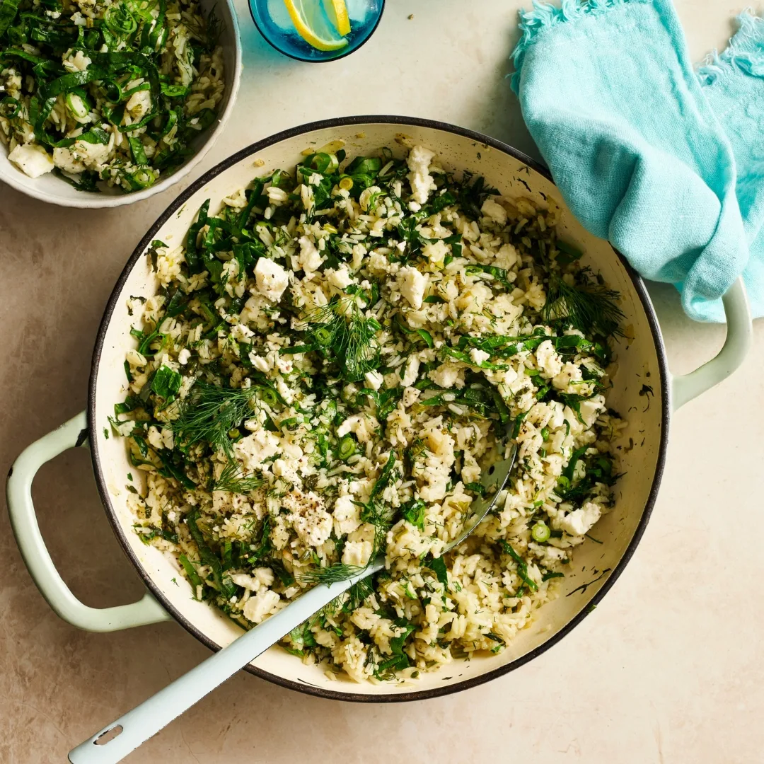 greek lemon rice in a pot with a spoon