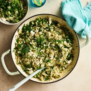 greek lemon rice in a pot with a spoon