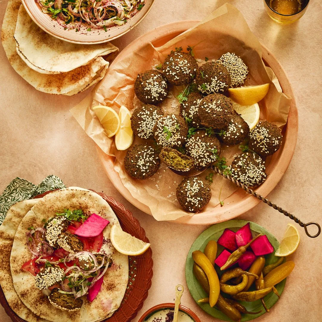 A plate of falafel with side dishes