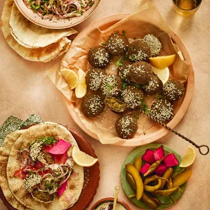 A plate of falafel with side dishes