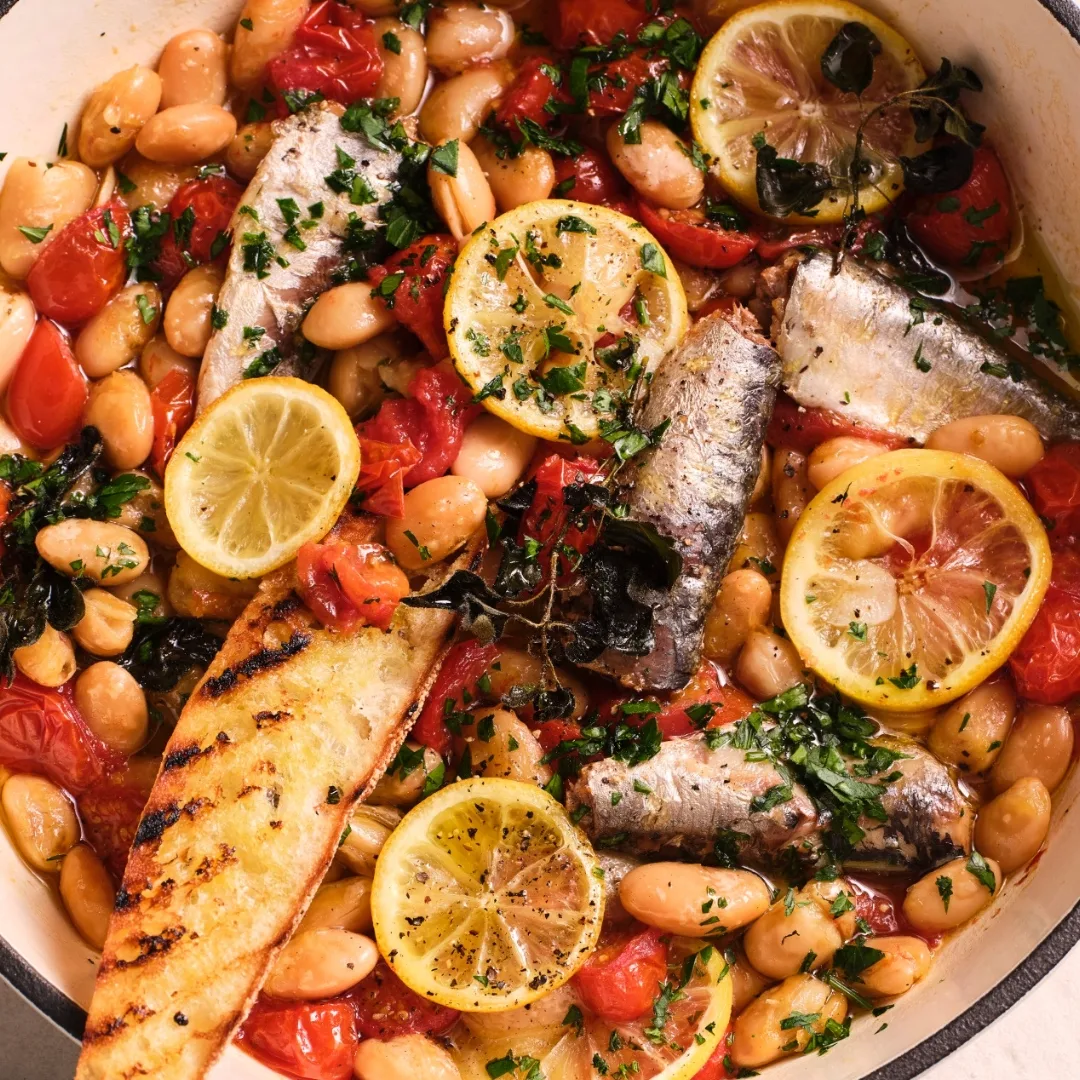 easy mexican beans with canned sardines, lemon slices, tomatoes and bread