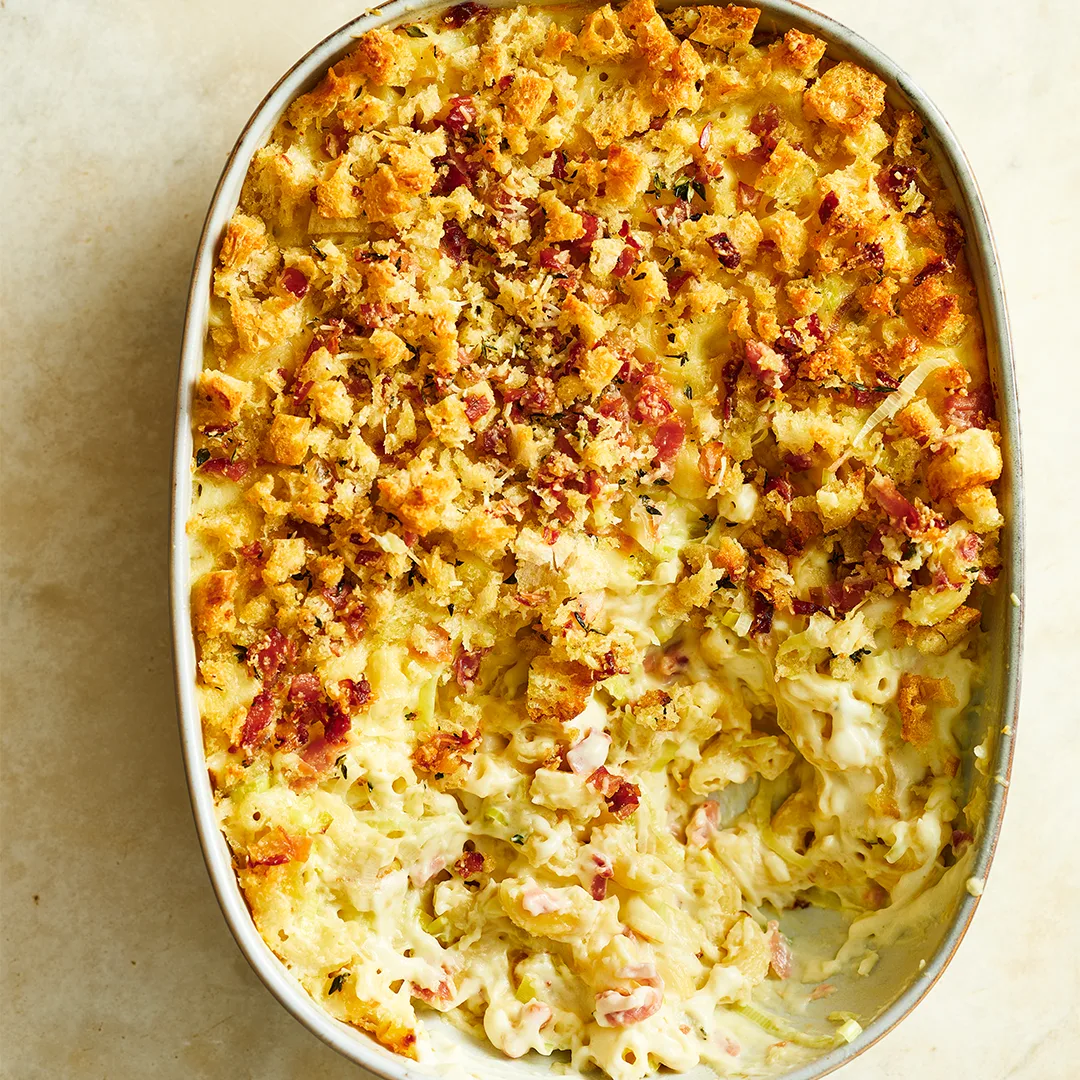 Overhead view of a baked macaroni and cheese casserole in an oval baking dish
