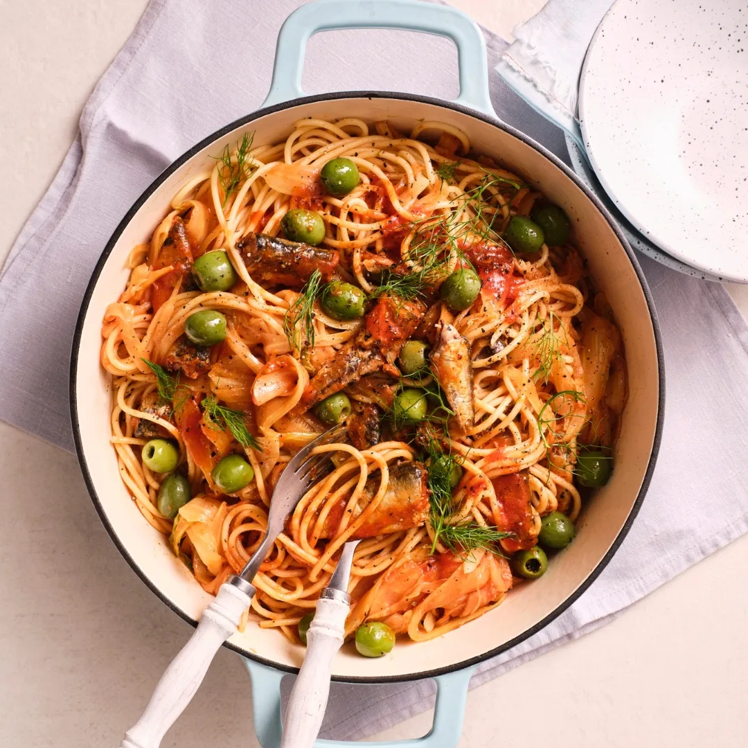 sardine & fennel spaghetti in a pot with serving utensils