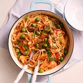 sardine & fennel spaghetti in a pot with serving utensils
