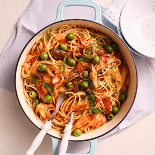 sardine & fennel spaghetti in a pot with serving utensils