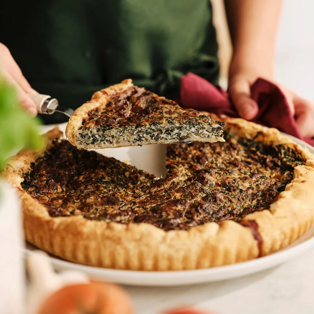 silverbeet and ricotta pie with a slice cut out