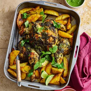 Depinder Chhibber's roast chicken with green chutney marinade in a baking tray with potatoes and lime wedges