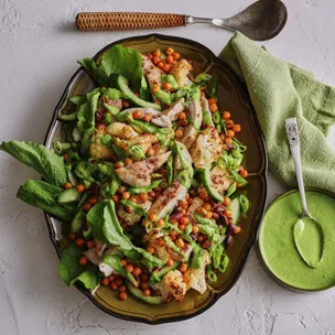roasted cauliflower salad with chicken & green dressing on a platter