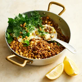 Chickpea and freekeh pilaf served in a shallow pan