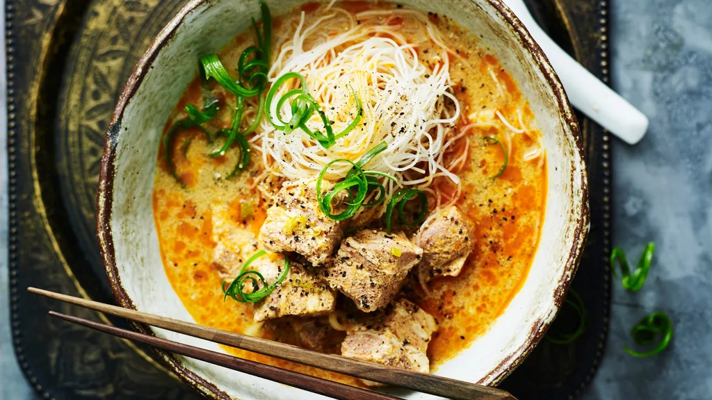bowl of slow cooker laksa topped with green onion