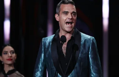 Robbie Williams jokes about post-baby boobs to pregnant reporter