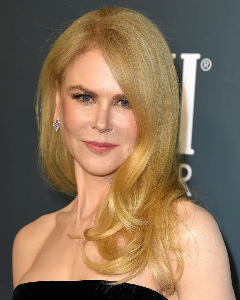 A strawberry blonde woman smiling.
