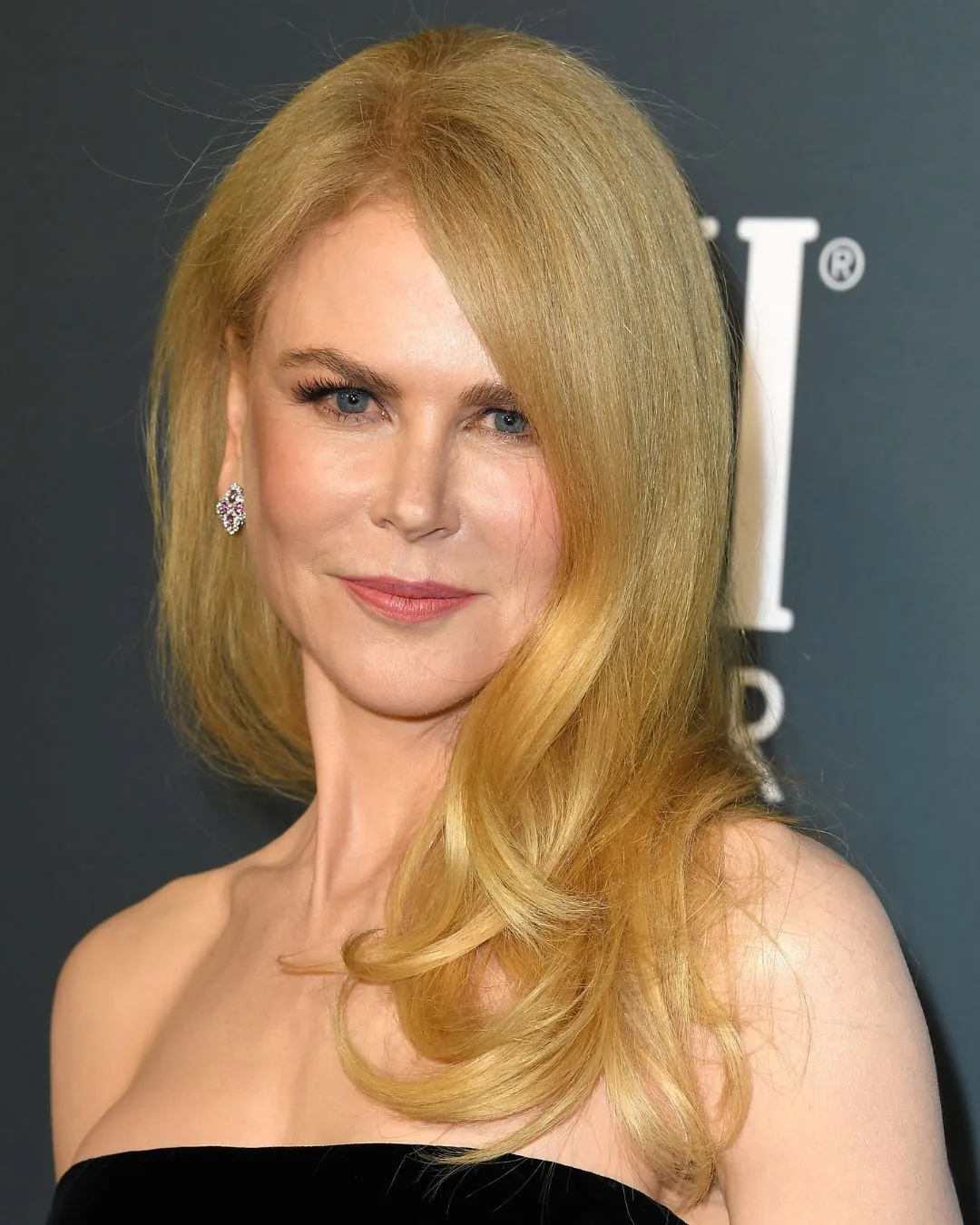 A strawberry blonde woman smiling. 