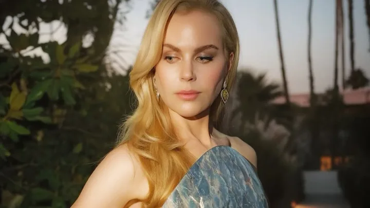 A Blonde woman looking over her shoulder