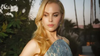 A Blonde woman looking over her shoulder