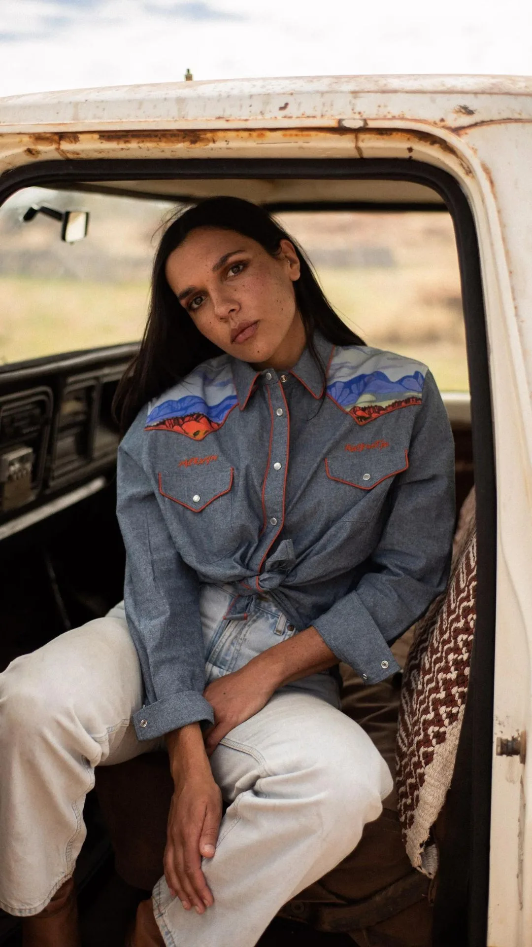 Lilie Madden poses from inside a car in a western style shirt