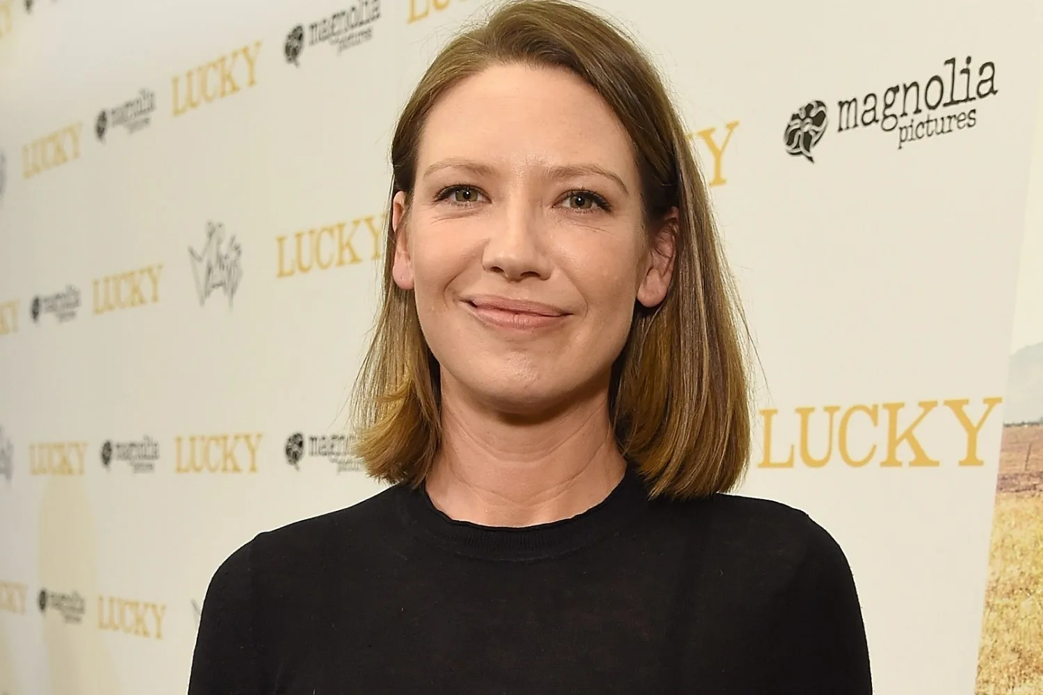 Person smiling at "Lucky" premiere with Magnolia Pictures logos on the backdrop.