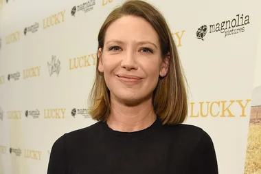Person smiling at "Lucky" premiere with Magnolia Pictures logos on the backdrop.