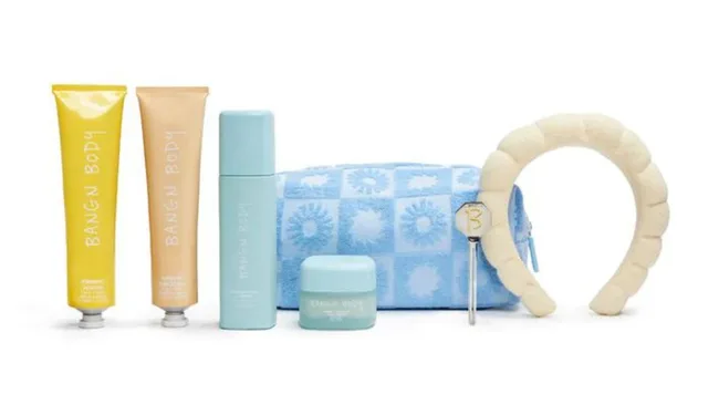 Bangn Body skincare set with creams, spray, headband, blue patterned pouch, and applicator tool on display.