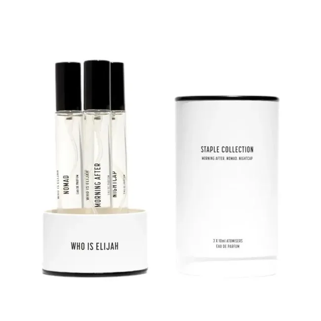 Three Who Is Elijah perfume bottles with a white cylindrical container labeled "Staple Collection."