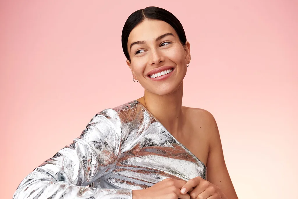 woman smiling in silver dress