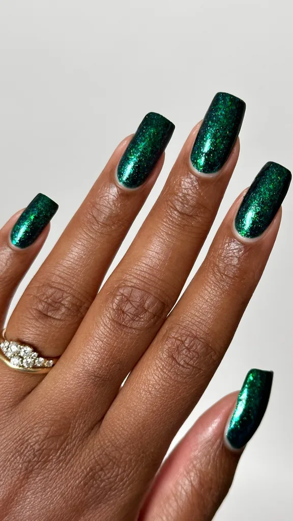 Dark green sparkle nail polish Christmas manicure