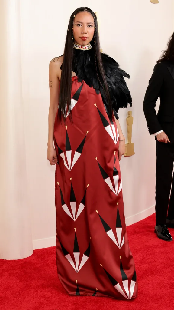 Quannah Chasinghorse in Red Berry Woman at the 2024 Oscars Red Carpet Fashion