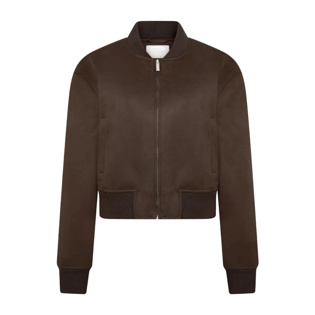 model wears a brown suede jacket 