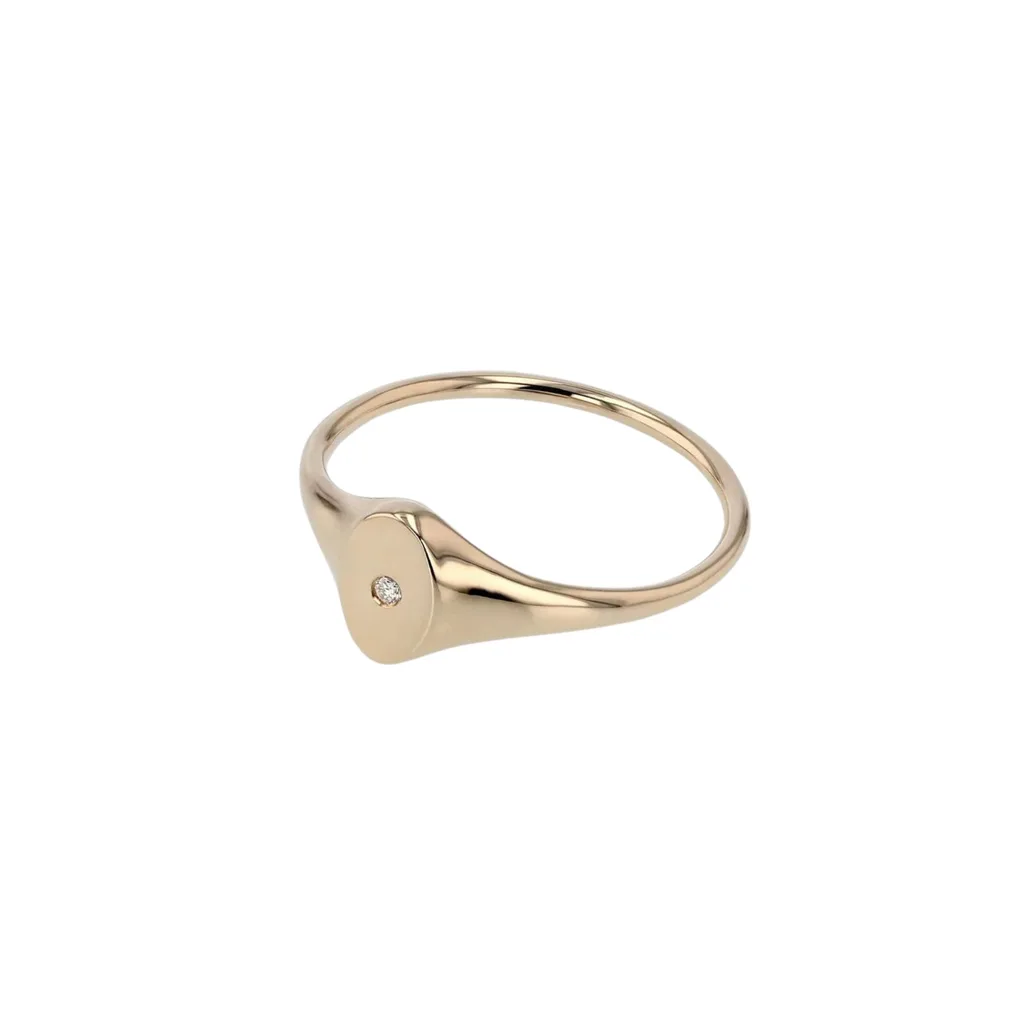 The featured petite oval diamond signet from Sarah & Sebastian is a delicate, modern interpretation of the traditional gold signet ring. The oval face features a single diamond set in 10k gold. The ultimate in understated luxury. 