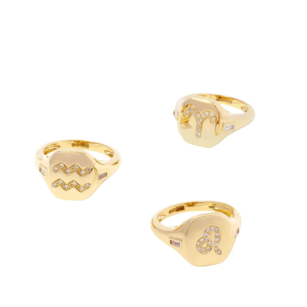 The Shay Zodiac 18k rings feature a large octagonal face with rounded edges and various zodiac signs in 0.01 carat diamonds and small rectangular diamonds on the band. 