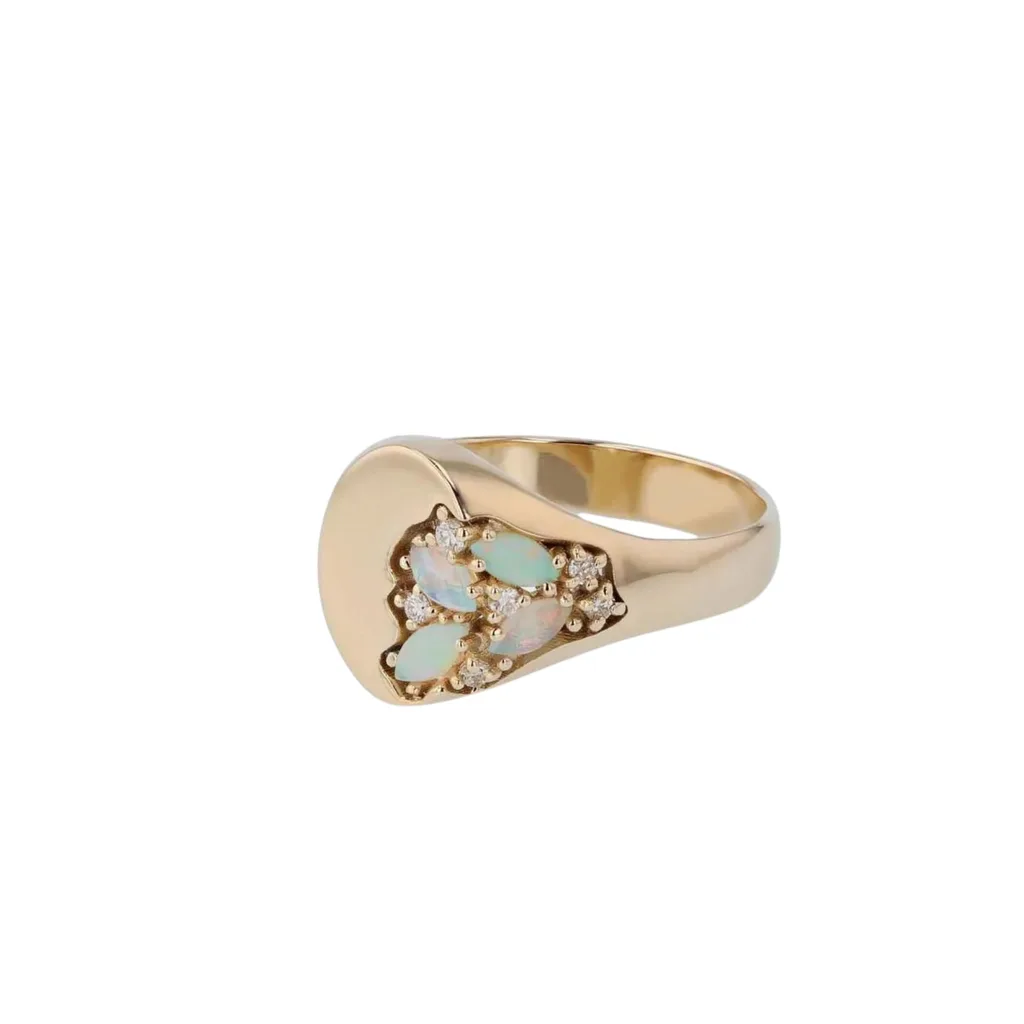 The Sarah and Sebastian Nymph Signet Ring has ethereal water-nymph vibes and features exposed Australian marquise opal cabochons and melee diamonds in 10k gold, embedded in a oval face.