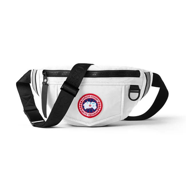 White Canada Goose waist bag with logo patch and black straps.