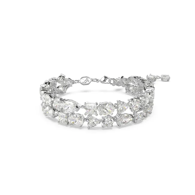 Elegant diamond bracelet with various-shaped sparkling stones set in a looped design.